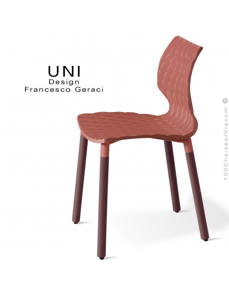 Chaise UNI, piétement bois de hêtre rond, vernis brun. Assise coque plastique effet matelassé couleur rouge corail.